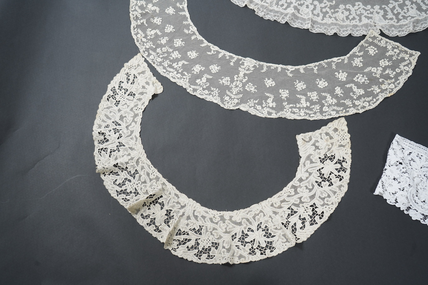 Seven late 19th century collars and trimming, being a long wide length of bobbin lace trimming - 268cm, two similar Bruges cream lace collars, an Irish Carrick-ma-cross collar, a fine needle run collar and another with a